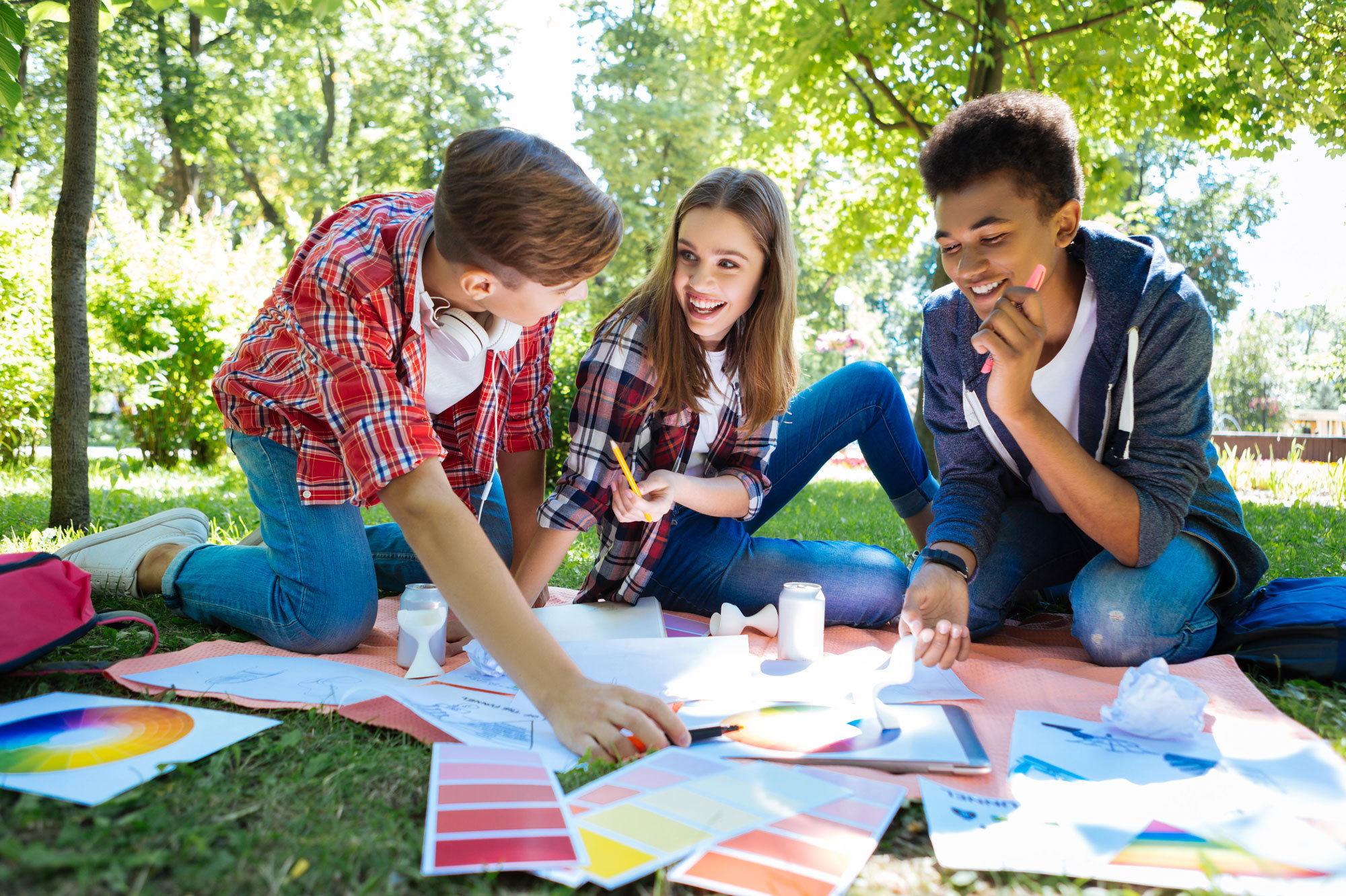 three smiling students working outside